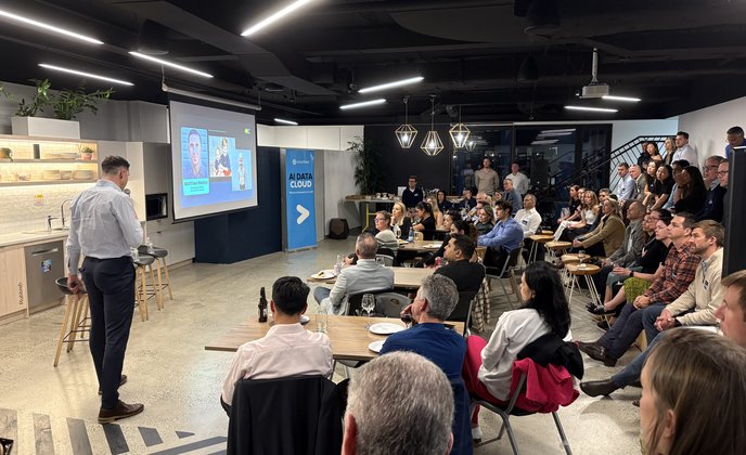 Photo of the speakers and audience at the AI in Cancer Research Event hosted by The Transformation Group